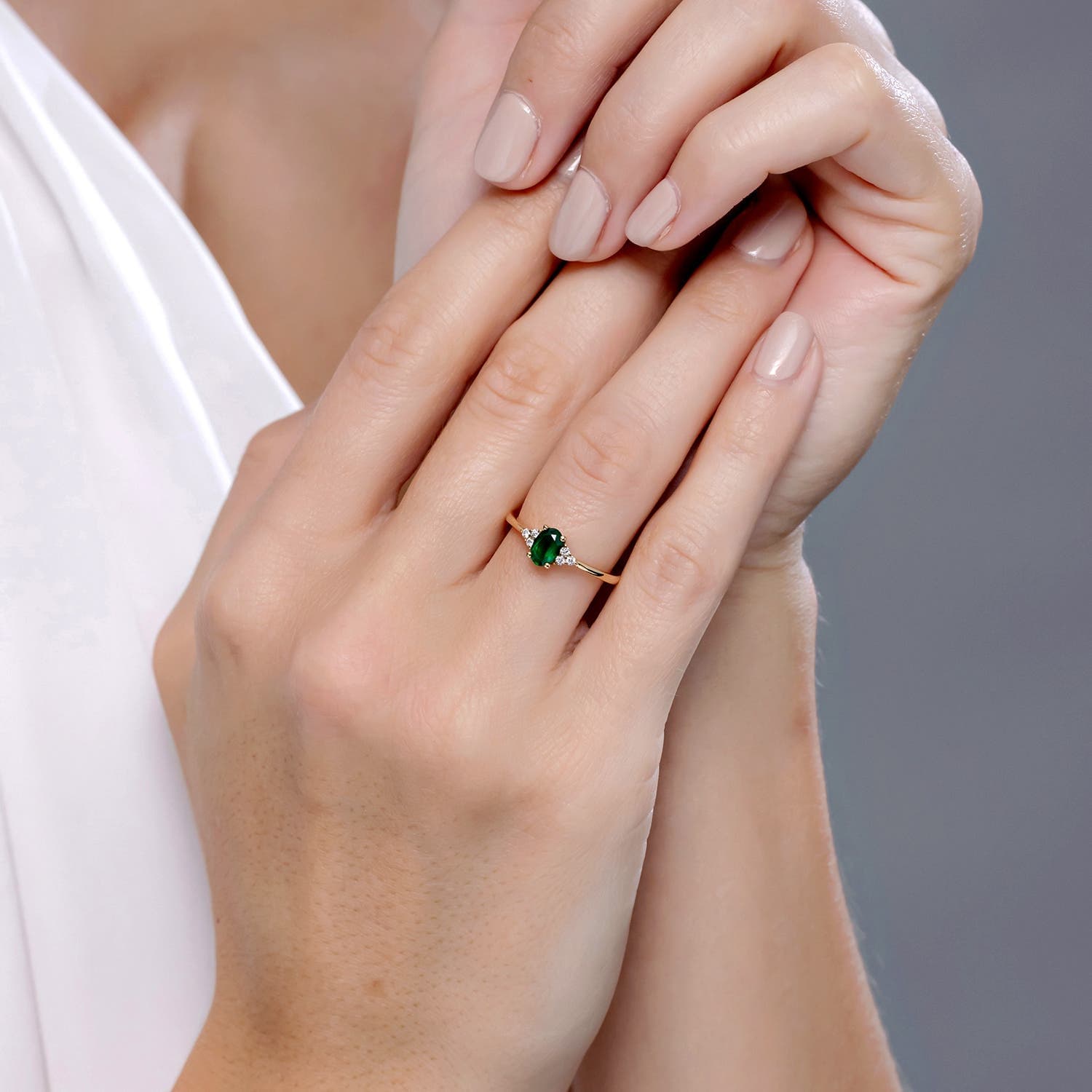 Solitaire Oval Emerald Engagement Ring with Trio Diamond Accents