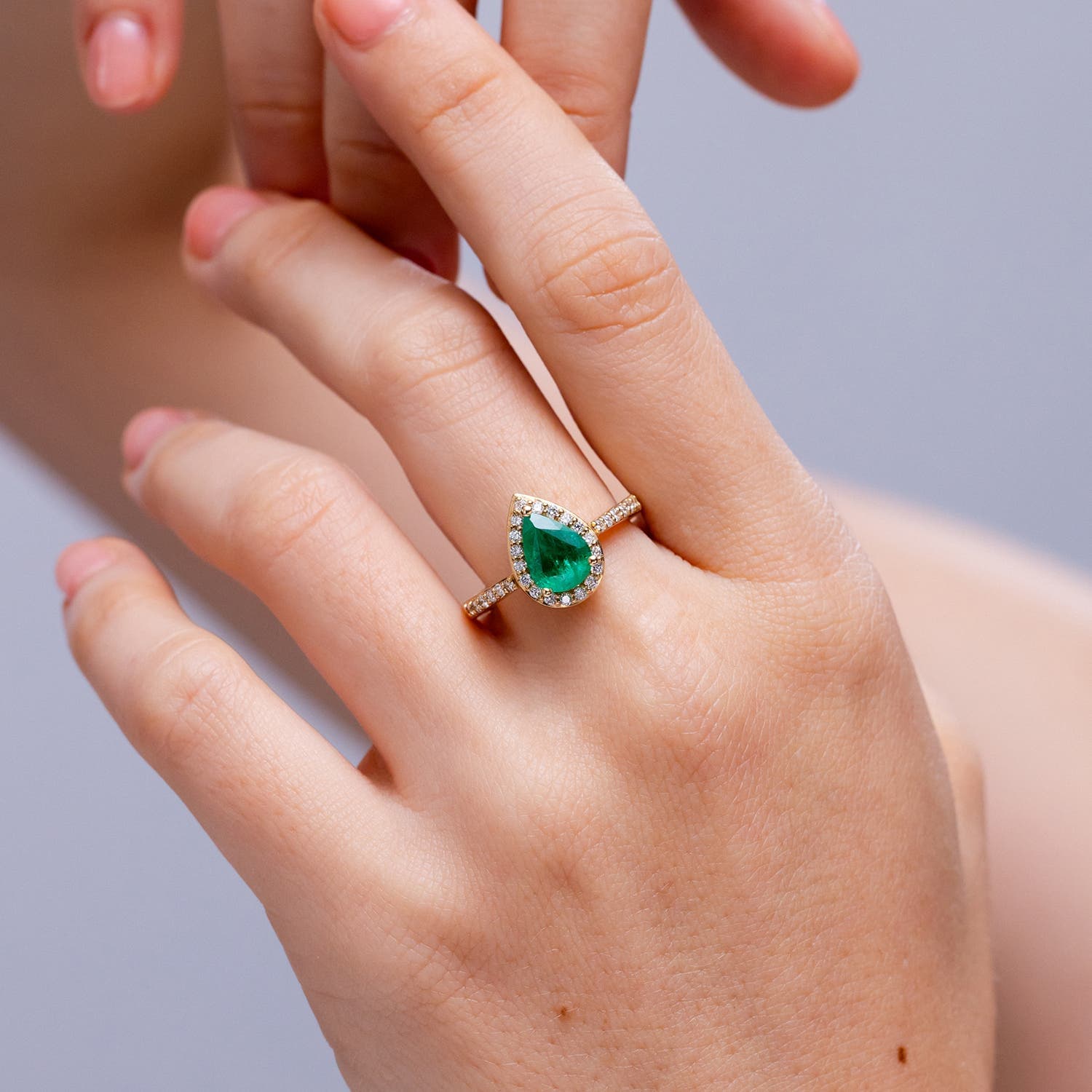 Prong-Set Pear Emerald Engagement Ring with Diamond Halo