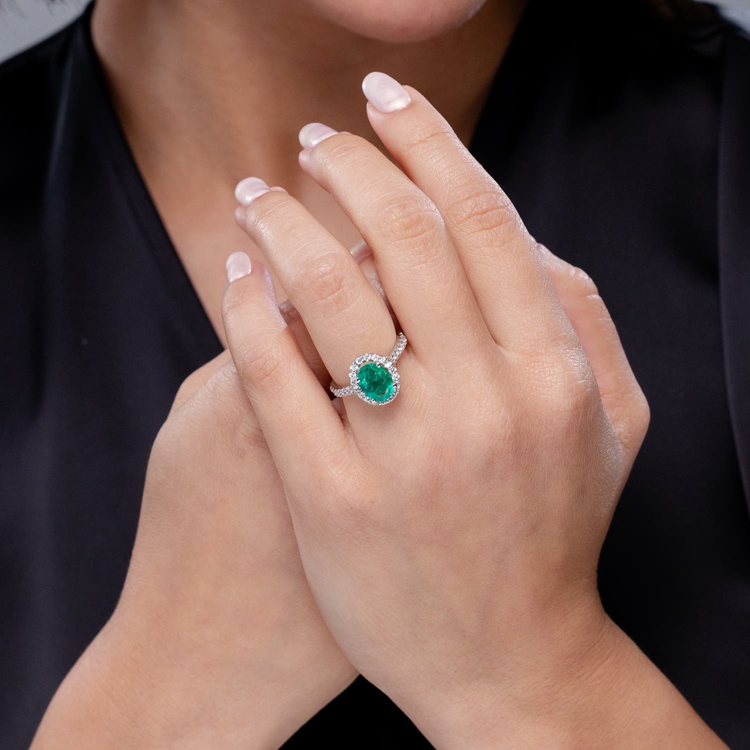Prong-Set Oval Emerald Halo Engagement Ring with Diamond Accents
