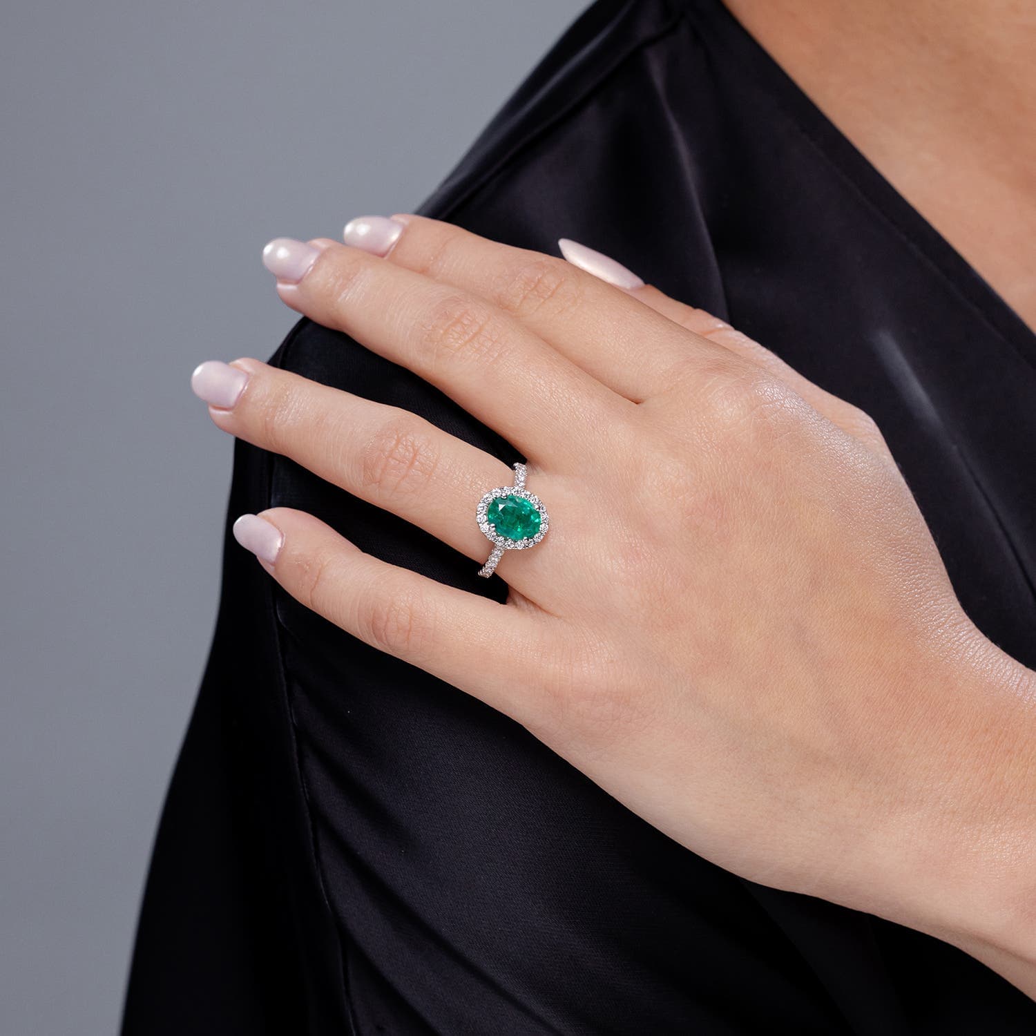 Prong-Set Oval Emerald Halo Engagement Ring with Diamond Accents