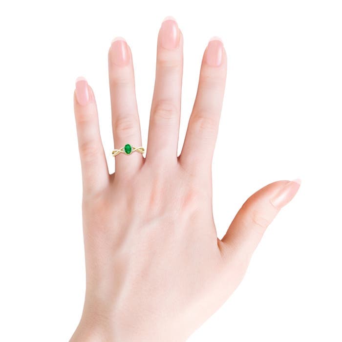 Oval Emerald Crossover Engagement Ring with Diamond Accents
