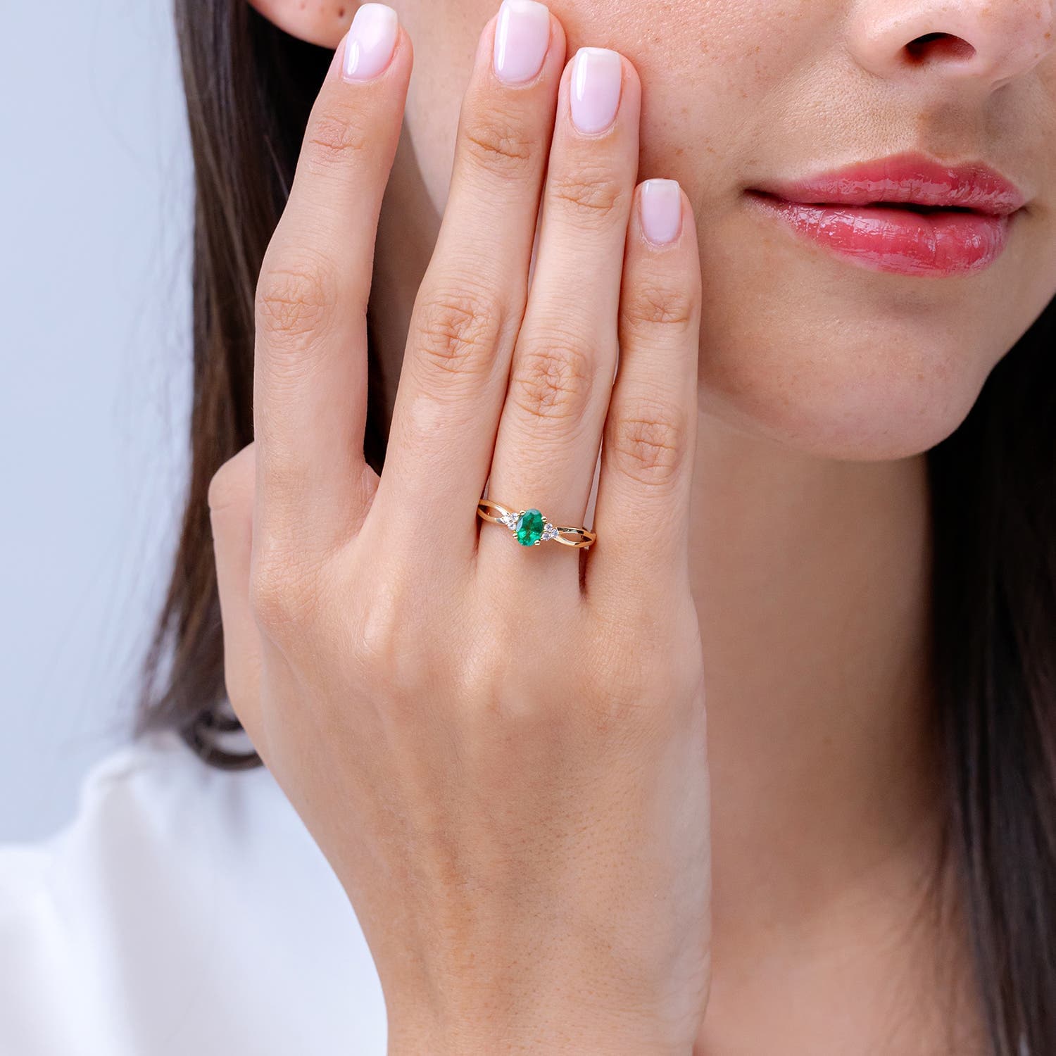 Solitaire Oval Emerald Split Shank Engagement Ring with Trio Diamonds